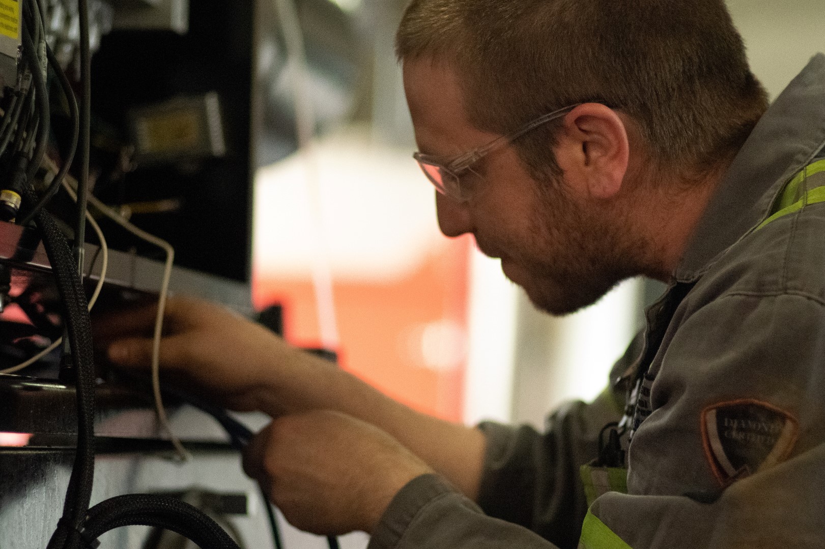 Journeyperson technician working on a Dawson Road Maintenance plow truck at Dawson International Truck Centres in Kamloops, British Columbia.