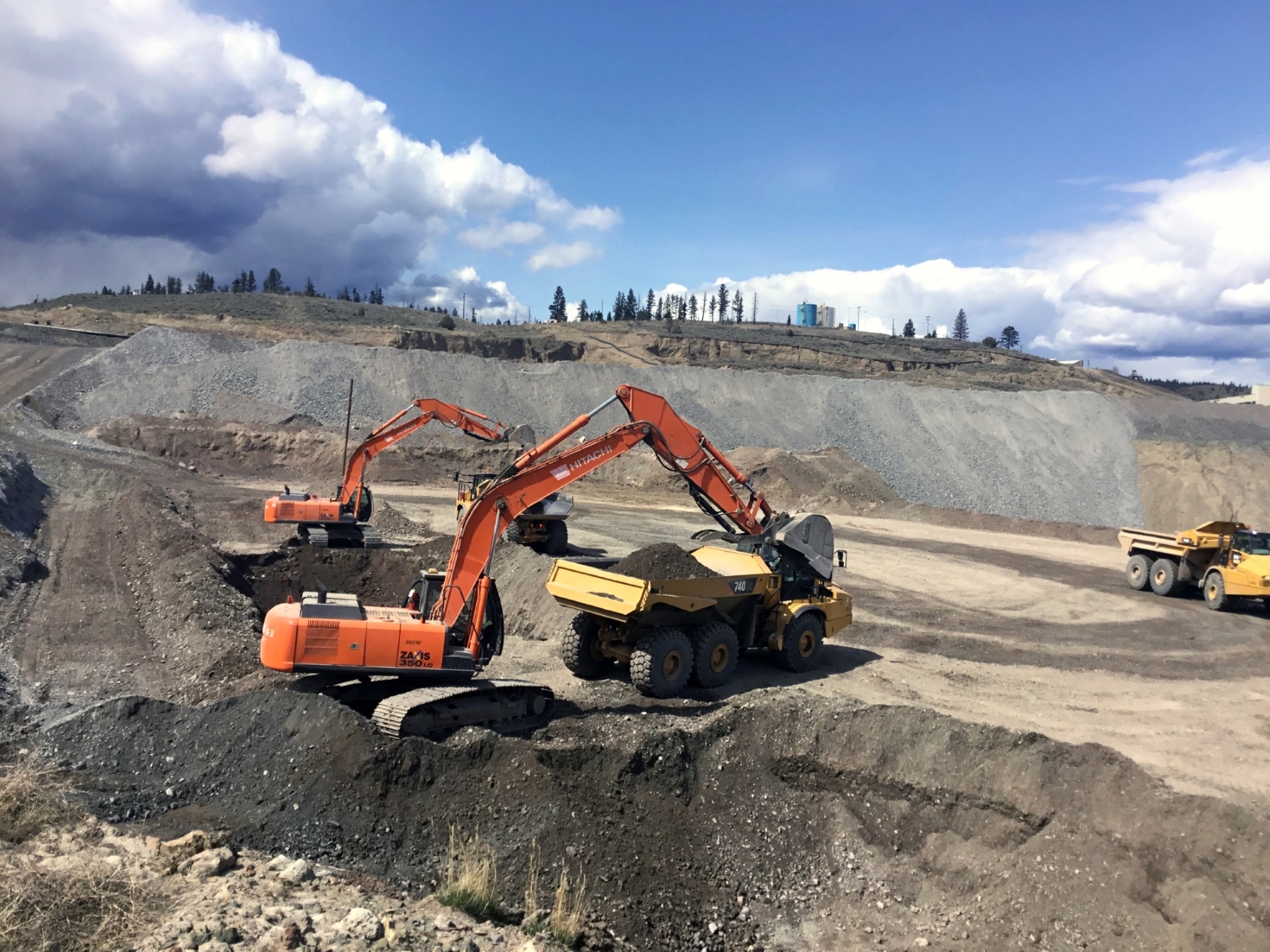 Dawson Civil excavator operators filling rock trucks at a mine.